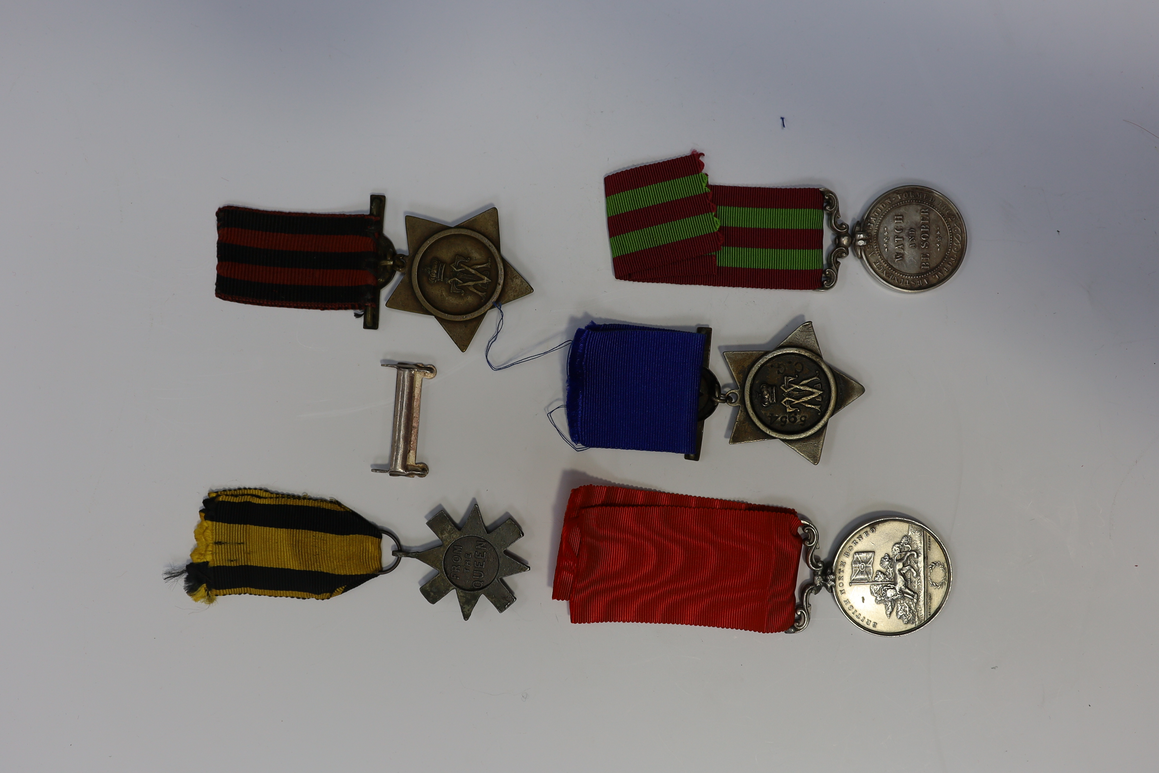 Replica medals; Khedive's Star 1884-6 and another undated; Ashanti star; Spink British North Borneo medal, a loose North West Frontier 1930-31 clasp and a Total Abstinence India medal 50-80